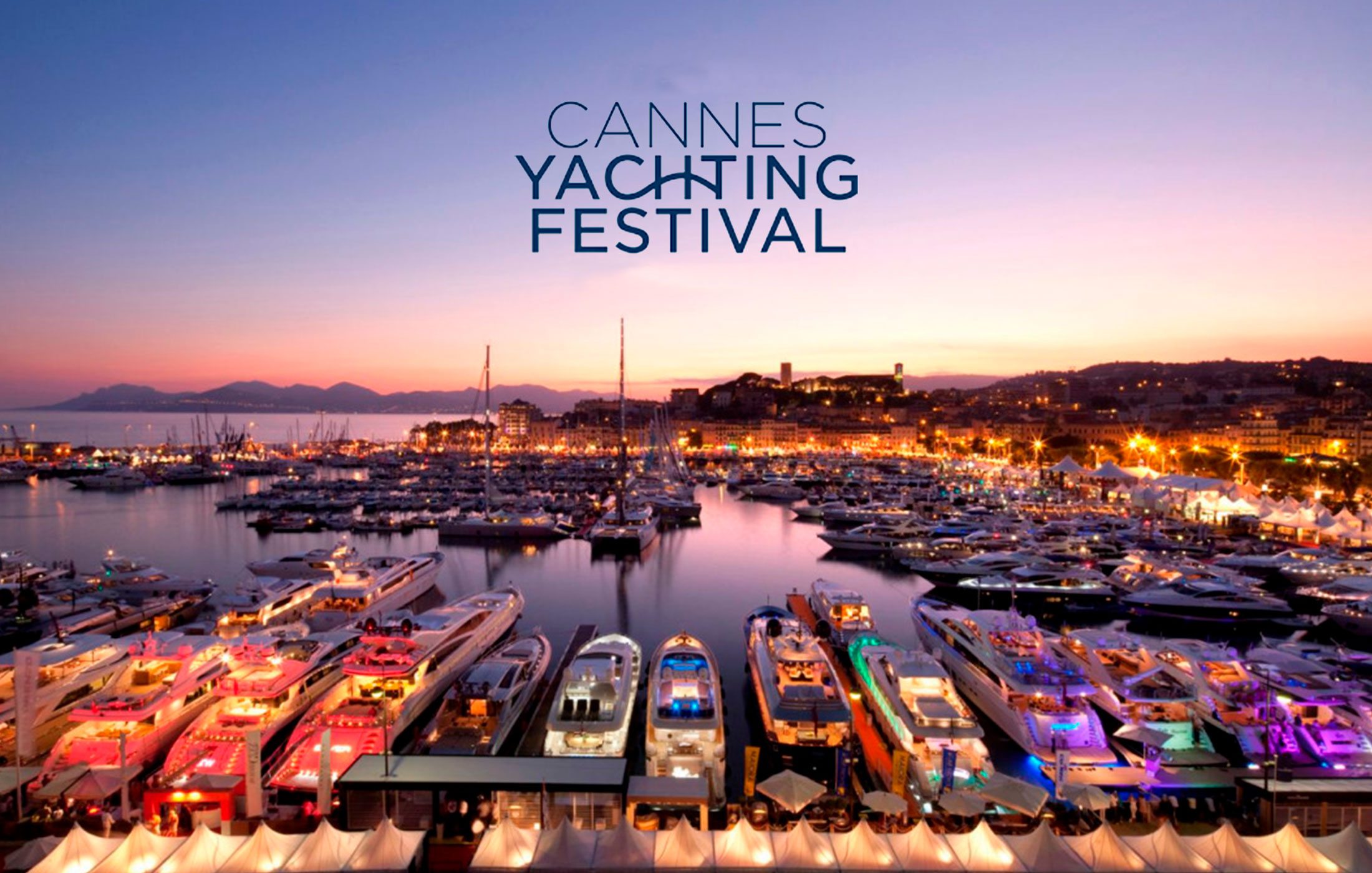 Luxury yachts lit up at Cannes Yachting Festival.