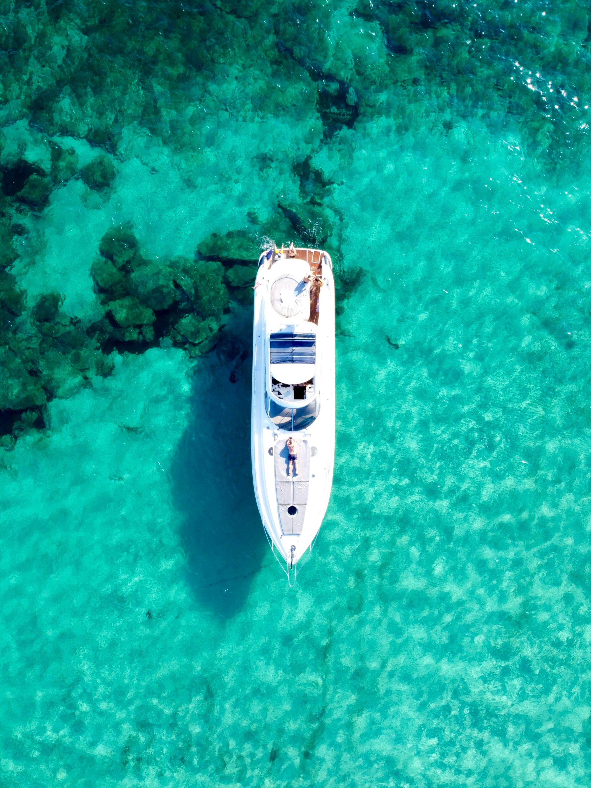 Luxury yacht anchored in clear turquoise ocean